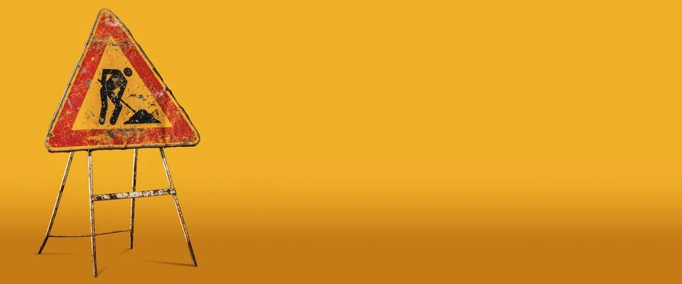 Men at Work or Work in Progress Sign on Orange Background Stock Photos