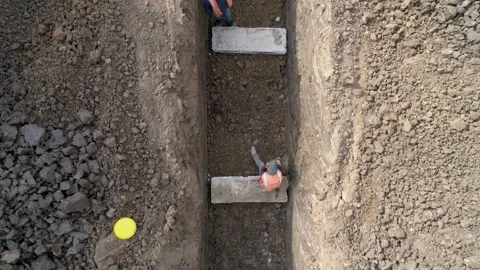 Men at work outdoor outside with heavy machinery loading arm installing water Stock Footage 131013259