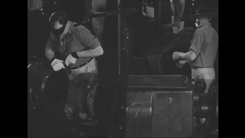 Men work on production line of automobile factory - 1939 Stock Footage 101983789