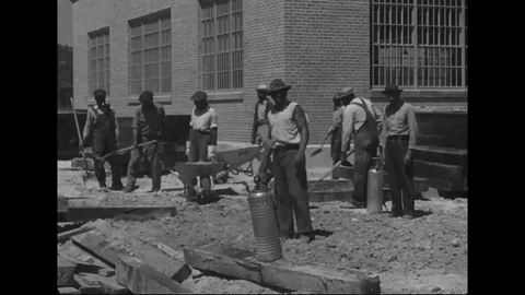 Men work on railroad tracks as well as station construction - 1940 Stock Footage 106660975