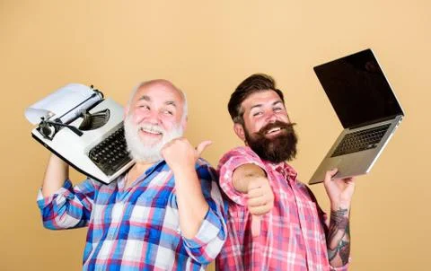 Men work writing devices. Digital technologies. Battle of technologies. Old Foto stock