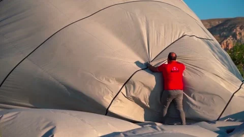 Men Workers are Packing Hot Air Balloons on the Ground Stock Footage 263136834