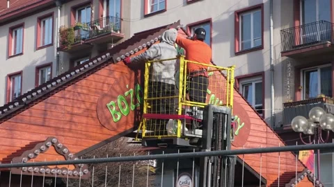 Men workers mount Christmas decorations at city fair. Preparation for New Year. Stock Footage 132771869