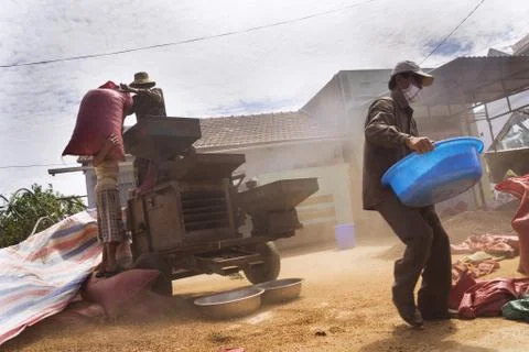 Men working on coffee beans sorting machine on street in Vietnam Stock Photos