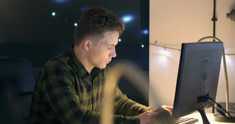 Men working on computer at desk at night Video stock 144271021