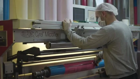 Men Working On Foil Wrapping With Mask And Gloves Stock Footage 143779706