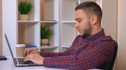 Men working at home typing on computer Stock Footage 86248356