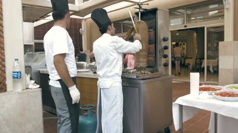 Men working in the kitchen and grilling kebab Stock Footage 65562239