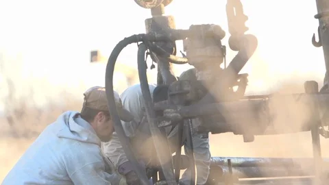 Men working in the oil fields at dusk in Texas Video stock 128648868