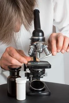 Men working with an old microscope Stock Photos
