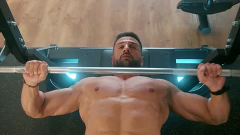 Men working out their arms on machines laying Video stock 239553211