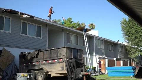 Men Working on Roof Stock Footage 135990790
