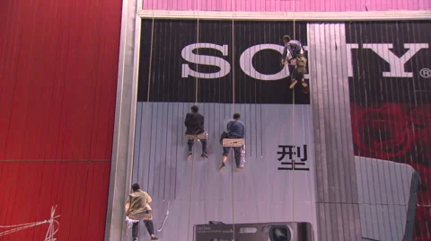 Men working on side of building in harnesses Video stock 52950495