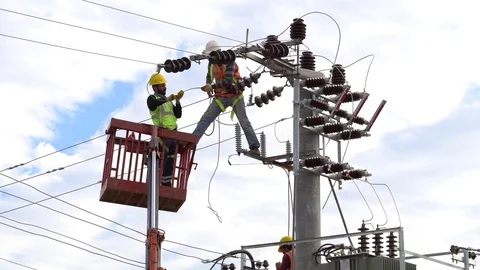 Men working on a transformer on a electricity power pole Stock Footage 83414717