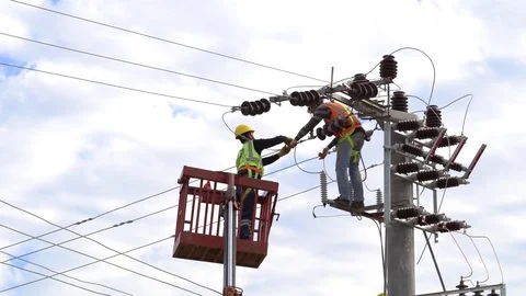 Men working on a transformer on a electricity power pole Stock Footage