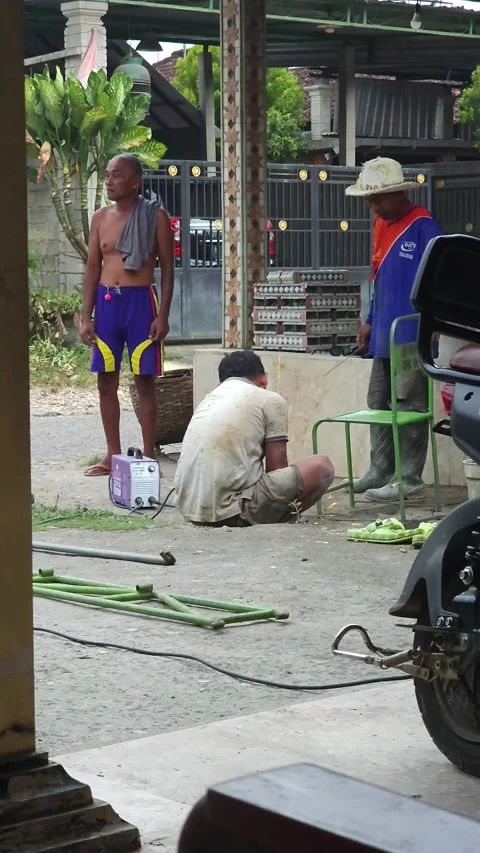 Men In Workshop Working With Angle Grinder And Welding Machine Stock Footage 340079038