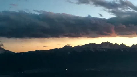 Menacing clouds covering the mountains of gray-yellow color and Stock Footage 256402994