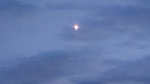 Menacing dark clouds on the blue sky and a brightly glowing young moon Stock Footage 256432817