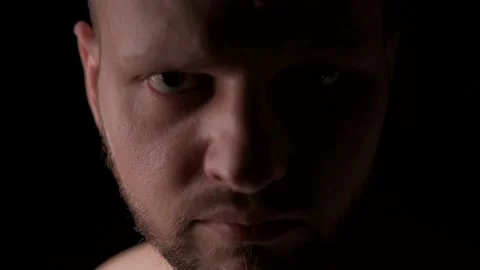 The menacing evil man advances menacingly and glares at the camera Stock Footage 138988451