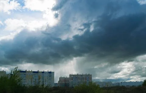Menacing rain clouds hung over multi-storey residential buildings 스톡 사진