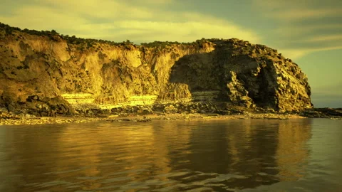 Menacing sky casts shadow on turbulent sea surface battering coast 스톡 동영상 333555015