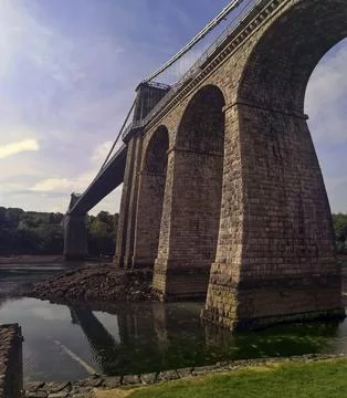Menai bridge low angle reflecting in the Straits in North Wales Fotos de archivo