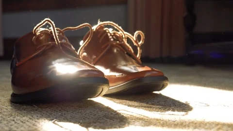 Men's Brown Dress Shoes Sitting In Sunlight, Slow Motion Fashion Elegance Reveal Stock Footage