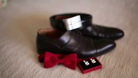 Men's cuff links on background of brown shoes Stock Footage 75256524