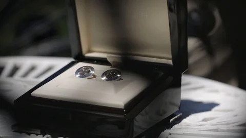 Men's cufflinks for a shirton on the table Macro slider closeup Stock Footage 93840436