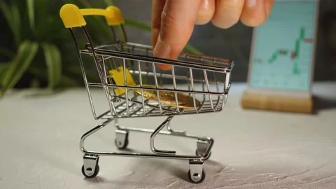Men's fingers stack Bitcoin cryptocurrency coins in a shopping cart Stock Footage 168889709