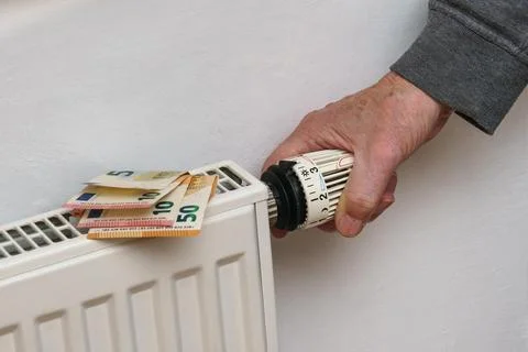 Men's hand on battery temperature controller heating, close-up. Stock Photos