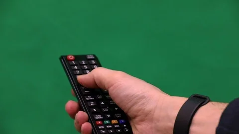 Men's hand. Large remote control. Right hand. Green screen. Press the button. 動画素材 103381566