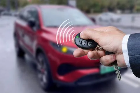 Men's hand presses on the remote control car alarm systems. Stock Photos