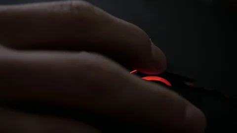 Men's hand scroll on mouse and press button in dark office. Stockbeeldmateriaal 106993704
