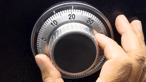 Men's hand is searching for a safe code. 库存影片 93327109