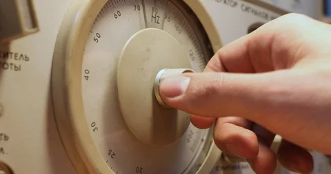 Mens hand setting Frequency on a device with round scoreboard Stock-Footage 122982335