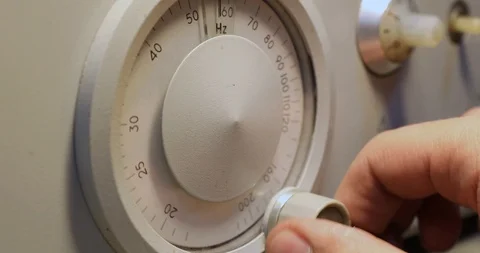 Mens hand setting Frequency on a device with round scoreboard Stock-Footage 122982499