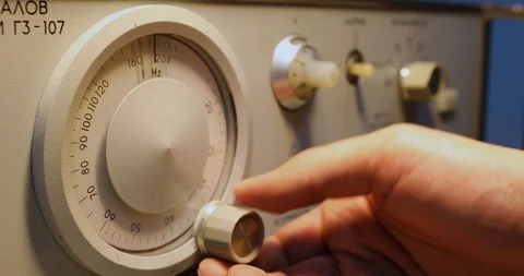 Mens hand setting Frequency on a device with round scoreboard Stock Footage 122982678