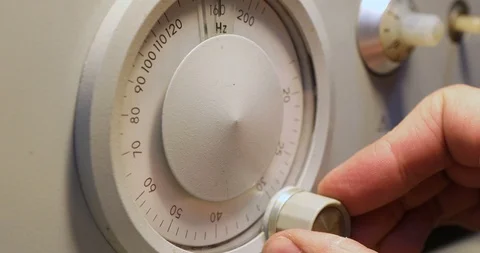 Mens hand setting Frequency on a device with round scoreboard Stock-Footage 122982762