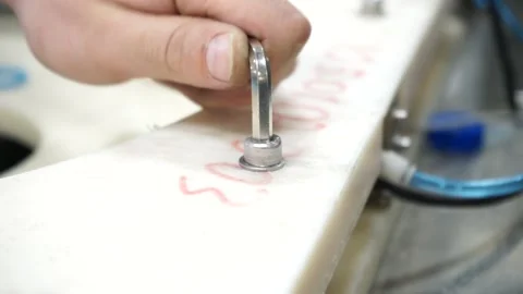 The men's hand twists the hexagonal key screw Stock Footage 137864201