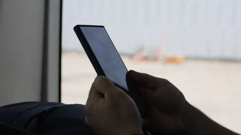 Mens hand typing in smartphone. Background airport. Stock Footage 270879963