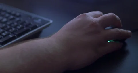 Men's hand using mouse in dark. Gamer playing at night. Close up Stock Footage 97883319