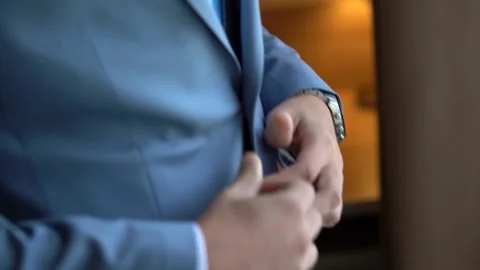 Men's hands adjust the button on the jacket, close-up Stock Footage 133437310