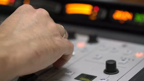 Men's hands on the armrests of the equalizer adjust the sound on the equalize Stock Footage 106525809