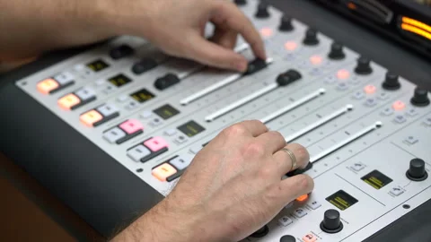 Men's hands on the armrests of the equalizer adjust the sound on the equalize Stock Footage 106525831