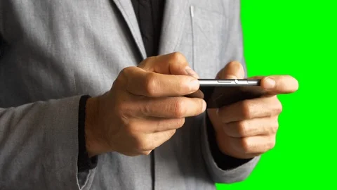 Men's hands on the background of the torso in a jacket using a smartphone Stock Footage 104410806