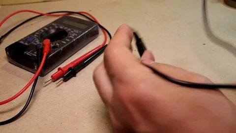 Men's hands bite off the wire with wire cutters Stock Footage 89545385