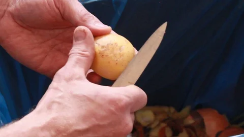 Men's hands clean potatoes Stock Footage 87083864