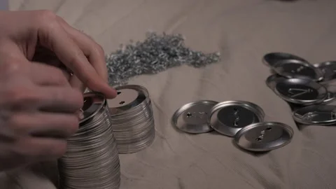 Men's hands close-up, attach pins to the blanks of badges Stock Footage 142754402