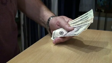 Men's hands count Dolar bills and put them on the table Stock Footage 79782800